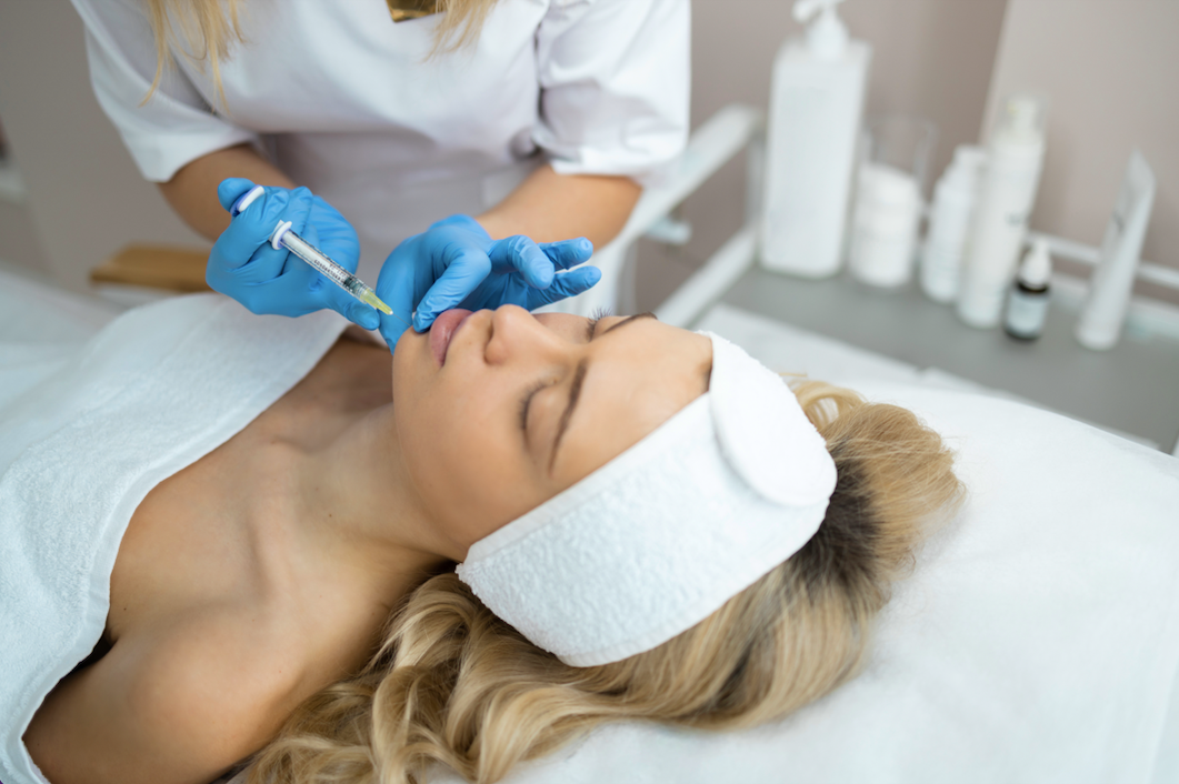 A woman receiving an injection in her chin