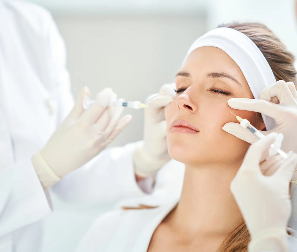 A woman receiving chin augmentation injections.
