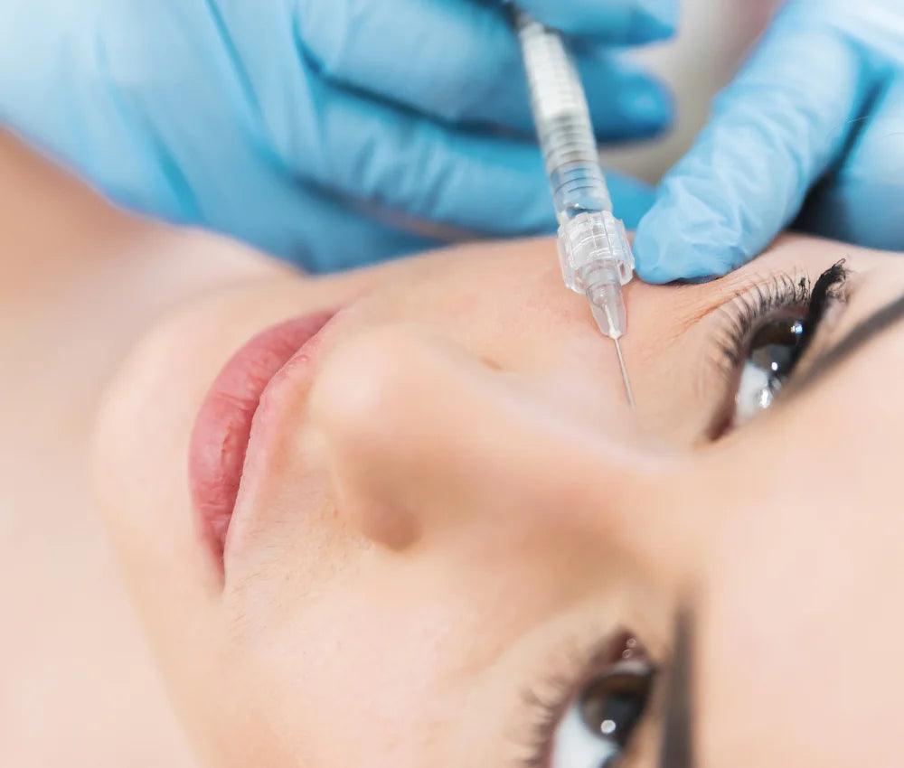 A woman receiving tear troughs injection at Laviel clinic